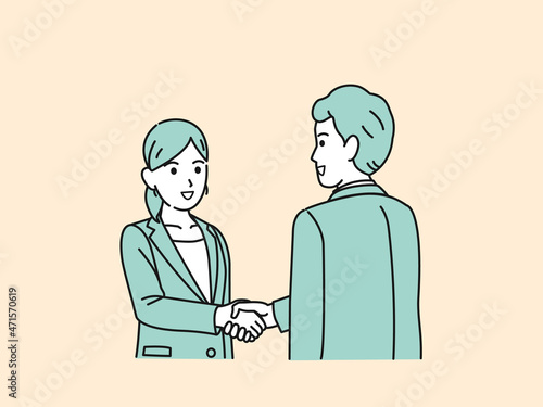 握手をする　スーツ姿の男女　会社員　仕事　挨拶　取引　合意　依頼　ビジネス photo