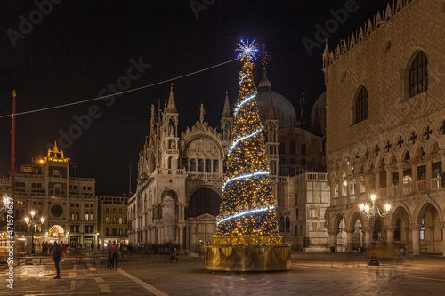 Night view of Christmas tree in San Marco square  Venice  Italy. Trail effect of unrecognizable people in motion