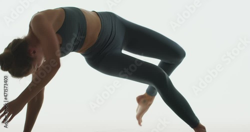 Yoga practice by coach graceful girl doing Wild Thing Pose Camatkarasana, lifestyle wellness, body and mind care concept