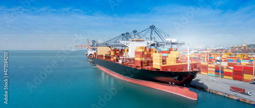 crane loading cargo container from truck to container ship in the international terminal logistic sea port concept freight shipping by ship, webinar banner forward mast