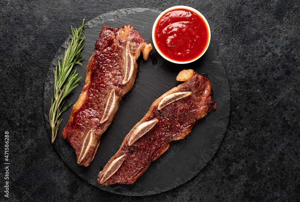 grilled marbled beef ribs on a stone background