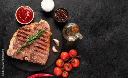 grilled t-bone steak with spices on a stone background  with copy space for your text