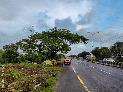 Car parked by the side of a highway in Chennai, India