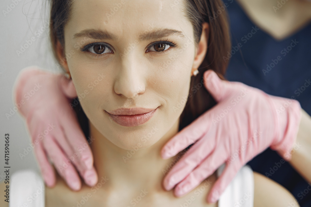 Woman with a doctor in cosmetology studio Woman with a doctor in cosmetology studio