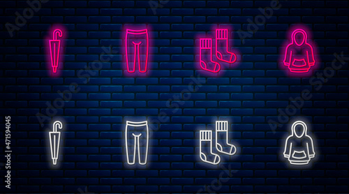 Set line Leggings, Socks, Umbrella and Hoodie. Glowing neon icon on brick wall. Vector