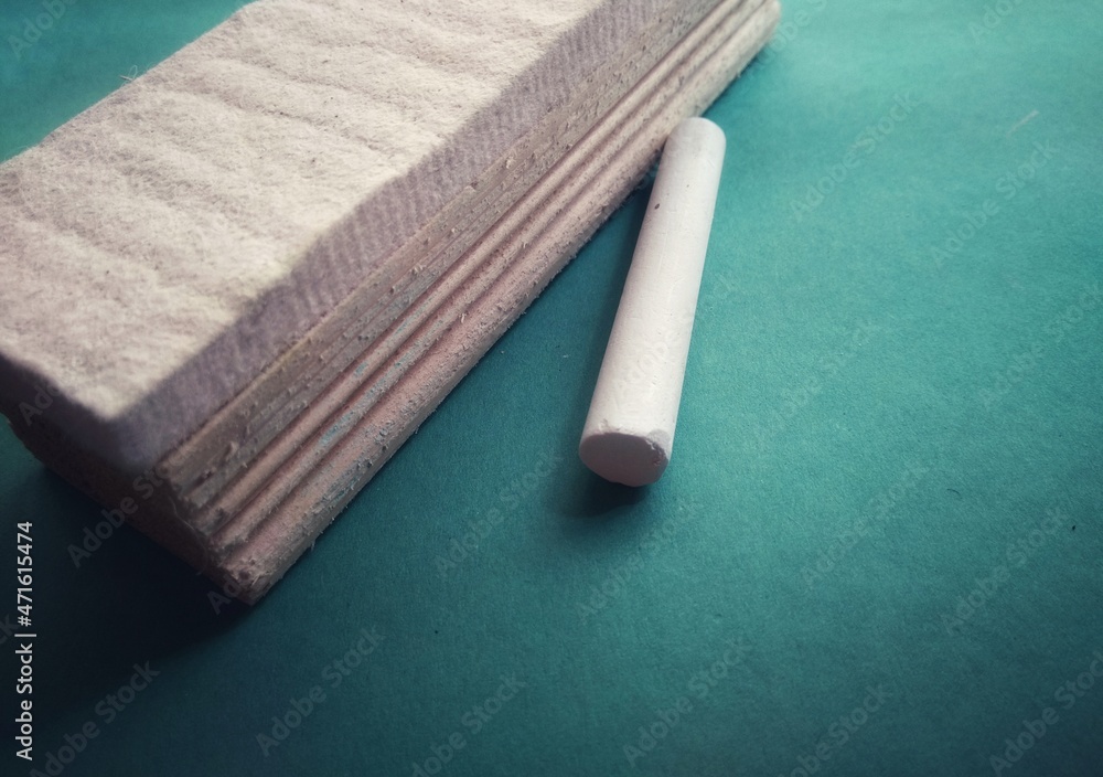 Chalk and duster or eraser on the green background. Method of education