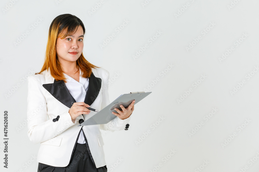 Portrait studio shot of Asian modern successful female businesswoman model in casual blazer suit look at camera holding pen writing report checklist on paper document clipboard on white background Portrait studio shot of Asian modern successful female businesswoman model in casual blazer suit look at camera holding pen writing report checklist on paper document clipboard on white background