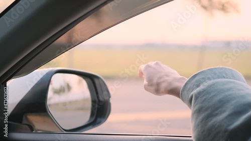 Wallpaper Mural free girl hand out of the window rides a car wind in the face. concept car travel on the road. girl stretches her hand out of the car window sun glare sunset. happy and freedom concept Torontodigital.ca