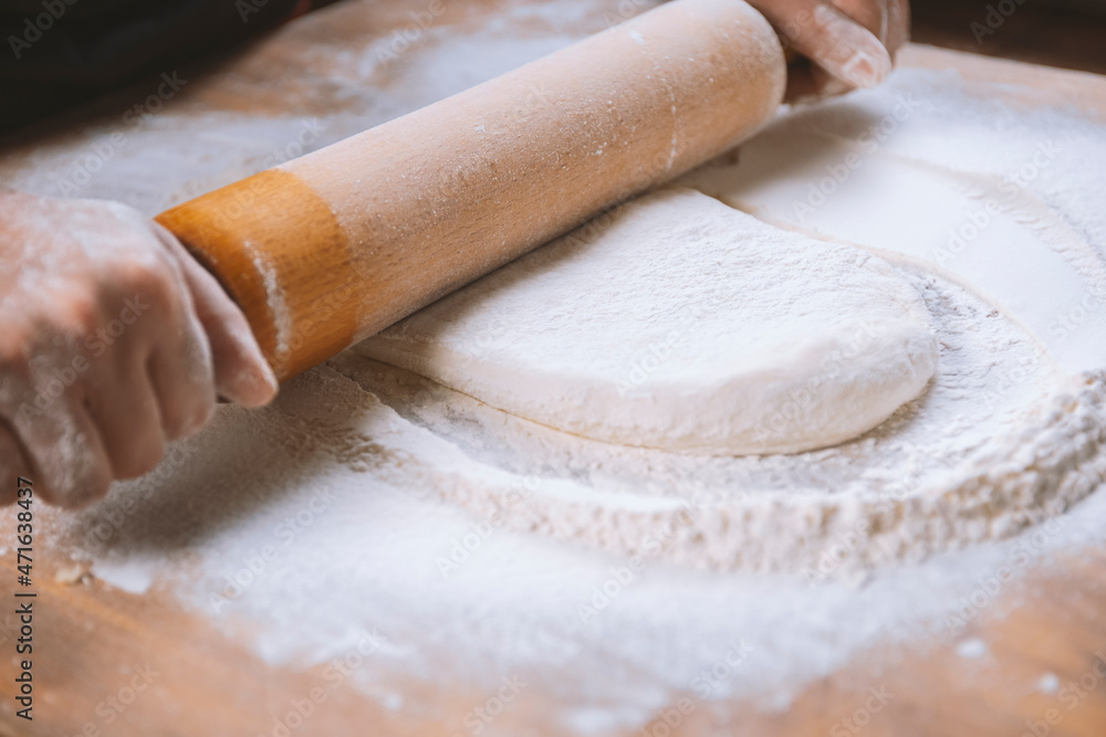 Baker kneading dough for pizza preparation. Chef cook making dough for baking pie on wooden table. Process preparation homemade pastry. Cooking pasta, bread,spaghetti,khachapuri, food concept Baker kneading dough for pizza preparation. Chef cook making dough for baking pie on wooden table. Process preparation homemade pastry. Cooking pasta, bread,spaghetti,khachapuri, food concept