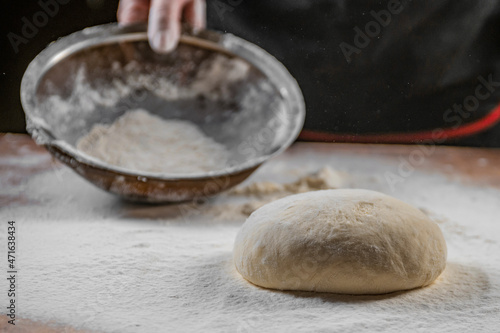Baker kneading dough. Chef cook making dough for baking pie on wooden table. Process preparation homemade pastry. Cooking pasta, bread,spaghetti,khachapuri, food concept