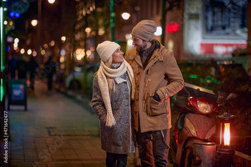 Man and woman on a romantic walk around a decorated city
