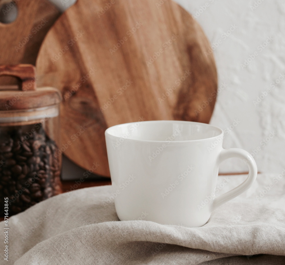Coffee mug mockup on the beige linen tablecloth in the modern kitchen interior . copy space.Business food brand template. Coffee mug mockup on the beige linen tablecloth in the modern kitchen interior . copy space.Business food brand template.