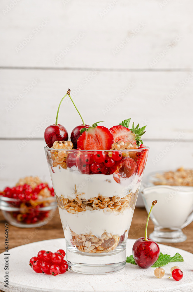 Healthy dessert of granola with yogurt and fresh berries on white wooden background. Copy space Healthy dessert of granola with yogurt and fresh berries on white wooden background. Copy space