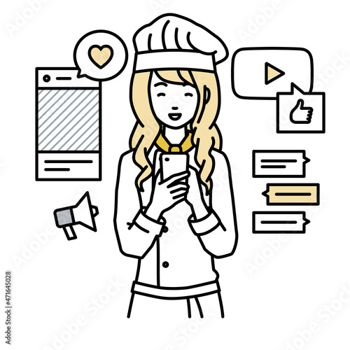 立ってスマートフォンでさまざまなSNSで楽しく交流する調理師の女性