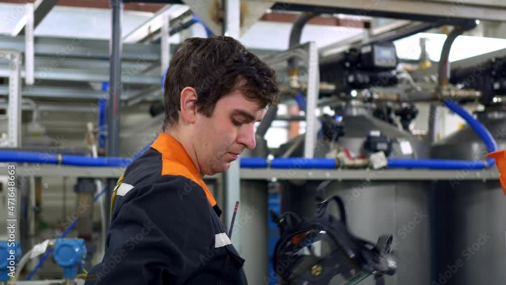 The rescuer takes off his uniform after a work shift, takes off his gas mask and work helmet. Work in hazardous production and industry. The rescuer takes off his uniform after a work shift, takes off his gas mask and work helmet. Work in hazardous production and industry.