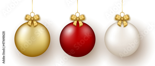 Christmas and New Year decor. Set of gold, white and red glass balls on ribbon with bow.