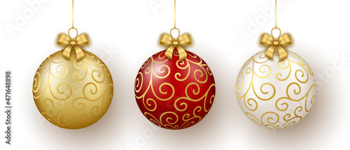 Christmas and New Year decor. Set of gold, white and red glass floral ornament balls on ribbon with bow.