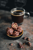 Handmade chocolate ferrero rocher in plate at dark background