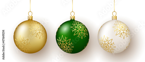 Christmas and New Year decor. Set of gold, white and green snowflake ornament balls on ribbon.