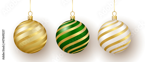 Christmas and New Year decor. Set of gold, white and green ornament balls on ribbon.