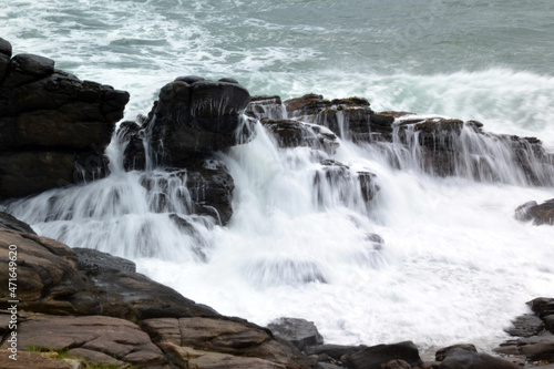 sri lanka  water breaks on rocks in the indian ocean