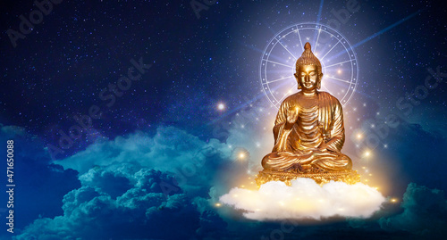 Buddha sit on a lotus cloud in the sky at night is the background © sarayut_sy