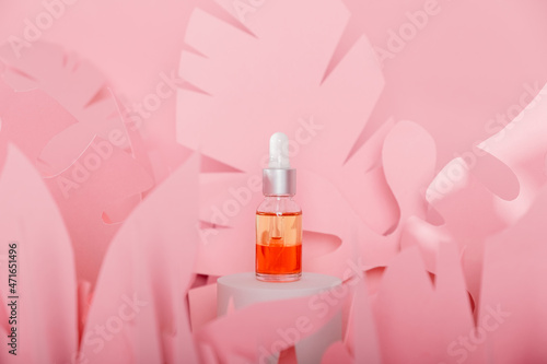 Dropper glass bottles with pipette standing on a white podium. Transparent hyaluronic natural beauty mineral product and eco serum skin care concept.