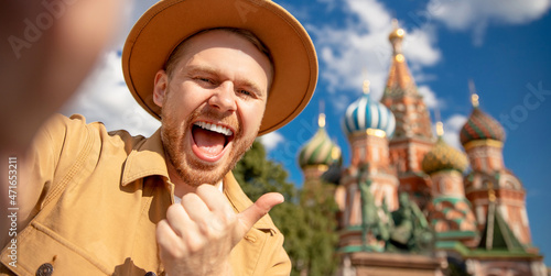 Photography Happy Young man traveler in brown hat taking selfie on Kremlin red square in Moscow