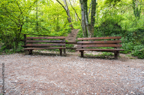 Two old wooden benches in the woods. Two old wooden benches for the rest.