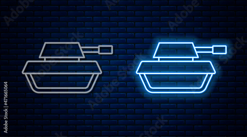 Glowing neon line Military tank icon isolated on brick wall background. Vector
