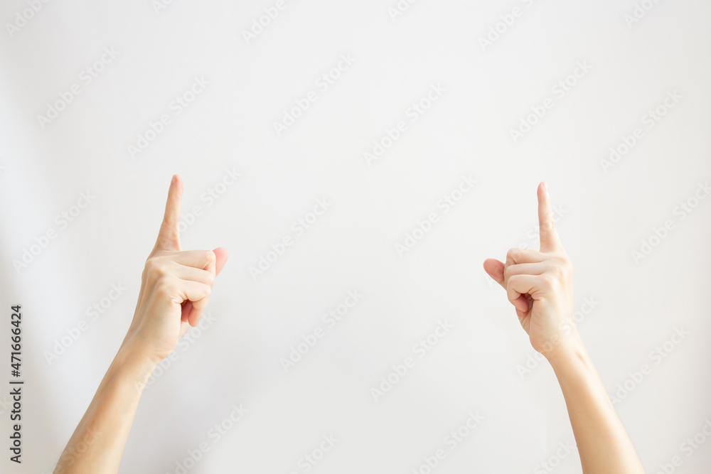 Two Woman's hand are pointing or indicating to copy space area for communication and advertisement and promotion and text on a white background Two Woman's hand are pointing or indicating to copy space area for communication and advertisement and promotion and text on a white background