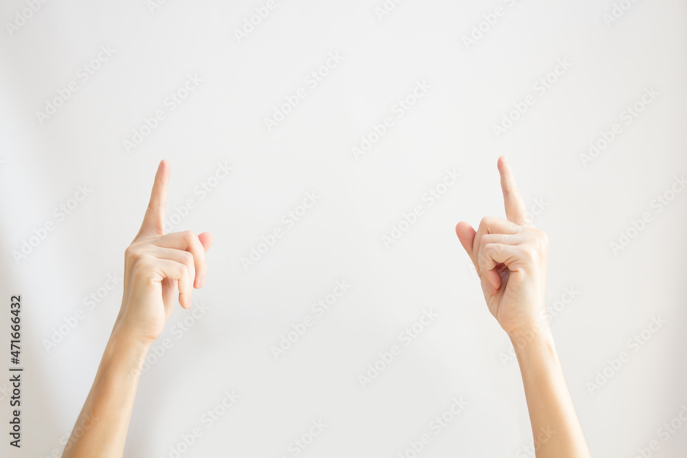 Two Woman's hand are pointing or indicating to copy space area for communication and advertisement and promotion and text on a white background Two Woman's hand are pointing or indicating to copy space area for communication and advertisement and promotion and text on a white background