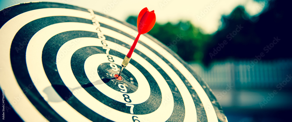 Bullseye or Bulls eye target or dartboard has dart arrow throw hitting the center of a shooting for financial business targeting planning and aim to winner goal of business concept. Bullseye or Bulls eye target or dartboard has dart arrow throw hitting the center of a shooting for financial business targeting planning and aim to winner goal of business concept.