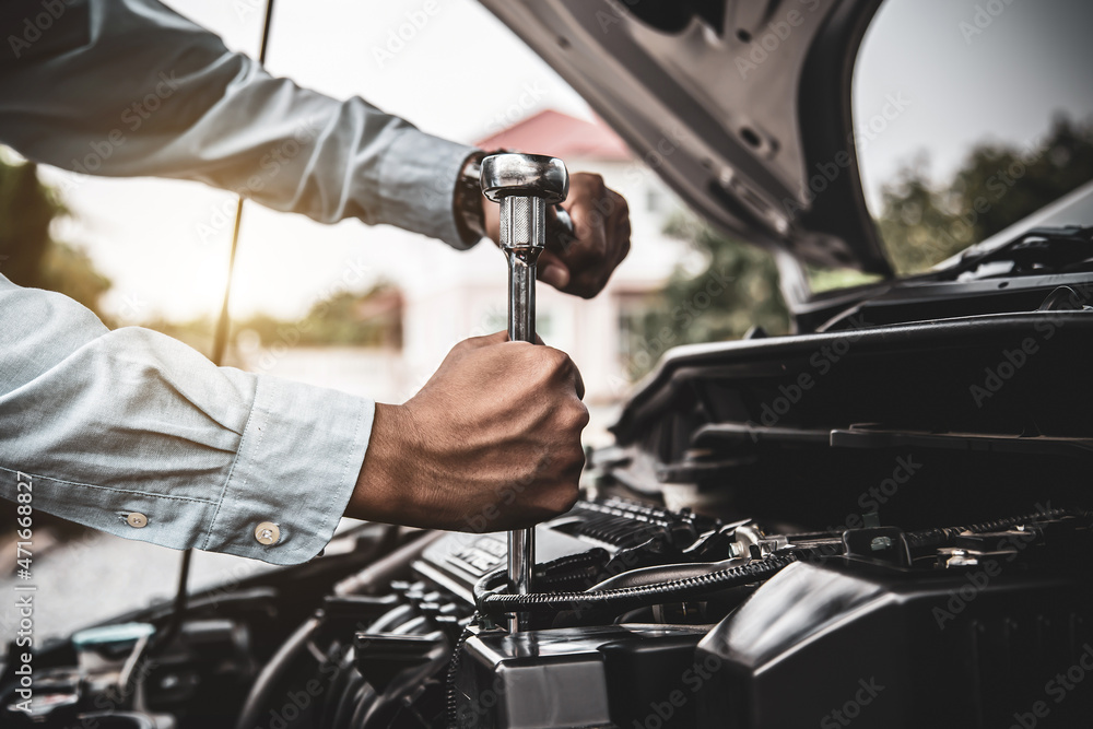 Car care maintenance and servicing, Close-up hand technician auto mechanic using the wrench to repairing change spare part car engine problem. Concepts of check and during periodic inspection service. Car care maintenance and servicing, Close-up hand technician auto mechanic using the wrench to repairing change spare part car engine problem. Concepts of check and during periodic inspection service.
