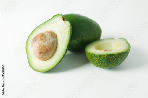 Avocado whole and half on white background. Natural food concept