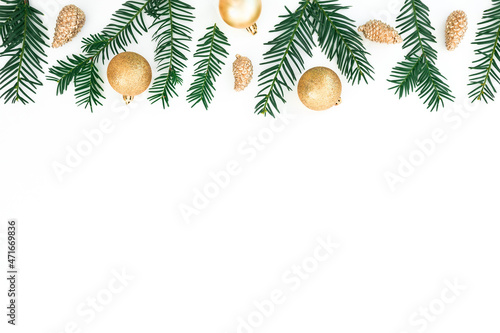 Christmas frame made of evergreen branches and golden decoration on white background. Flat lay