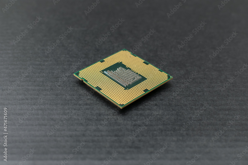 The computer microprocessor lies on a black table. Electronic components and spare parts The computer microprocessor lies on a black table. Electronic components and spare parts
