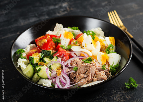 Healthy food. Tuna fish salad with eggs, lettuce, cherry tomatoes, cucumber and red onions. French cuisine.