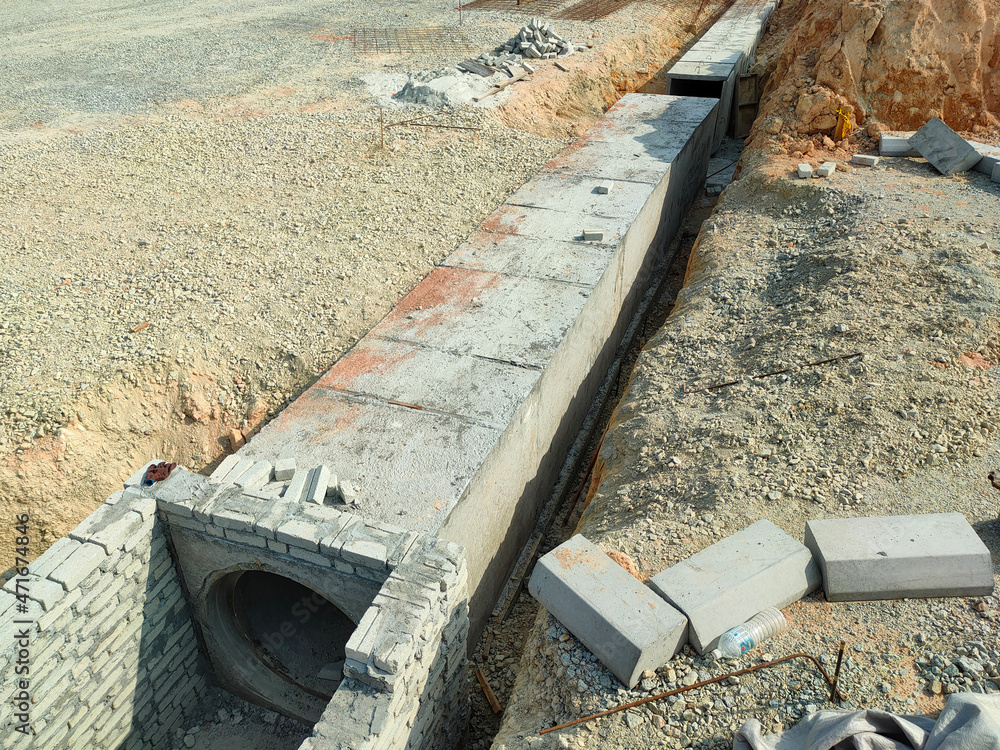 SELANGOR, MALAYSIA -JANUARY 22, 2021: Underground precast concrete box culvert drain under construction at the construction site. It is used to channel stormwater to prevent flash floods. SELANGOR, MALAYSIA -JANUARY 22, 2021: Underground precast concrete box culvert drain under construction at the construction site. It is used to channel stormwater to prevent flash floods.
