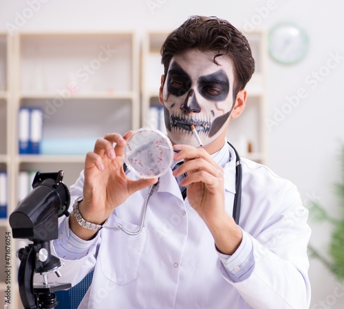 Scary monster doctor working in lab photo