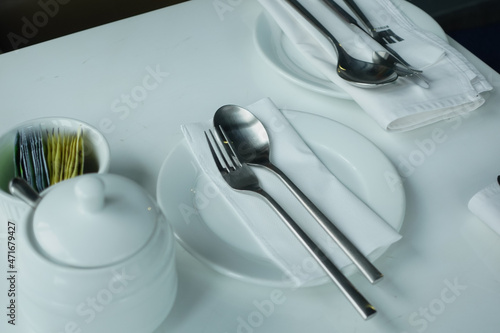 cutlery and empty plate on wooden background top down