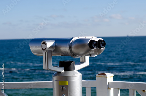 Observation binoculars. Observation deck by the sea. Walk by the sea.