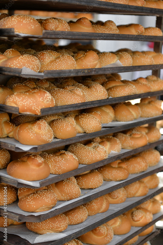 fresh buns in baking cabinets. bread on a baking sheet.
