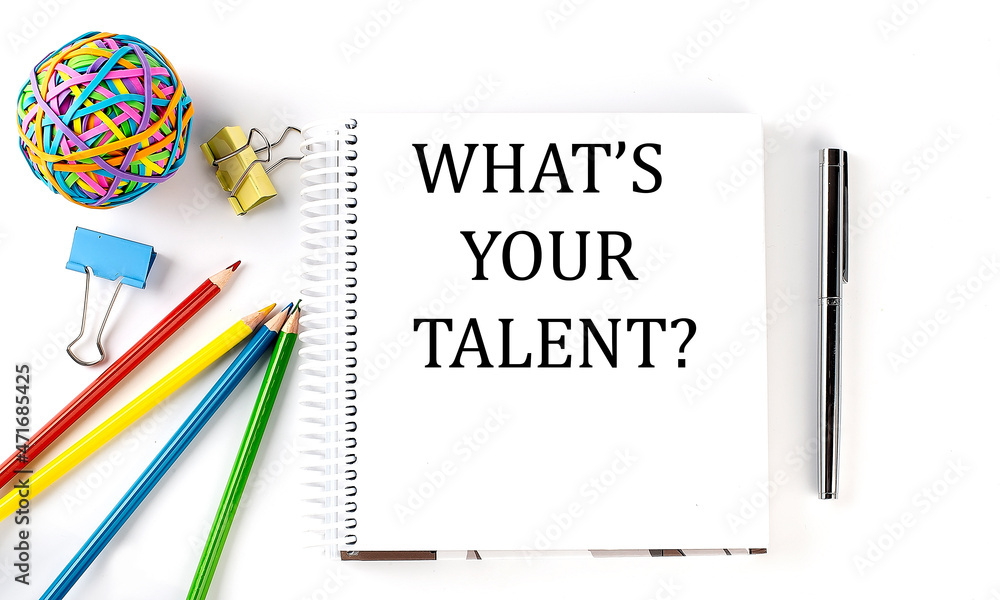 Notebook ,pencils,pen and rubber band with text WHAT'S YOUR TALENT on the white background Notebook ,pencils,pen and rubber band with text WHAT'S YOUR TALENT on the white background