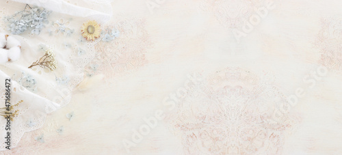 Background of white embroidered delicate lace fabric and dry flowers