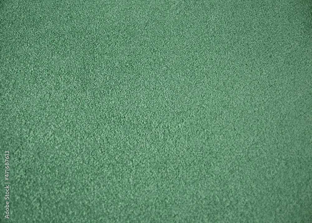 Fototapeta premium Green indoor office carpet texture. High resolution seamless monochrome wool fabric background. Interior material background top view. Short pile carpet. Blank generic microfiber textile texture.