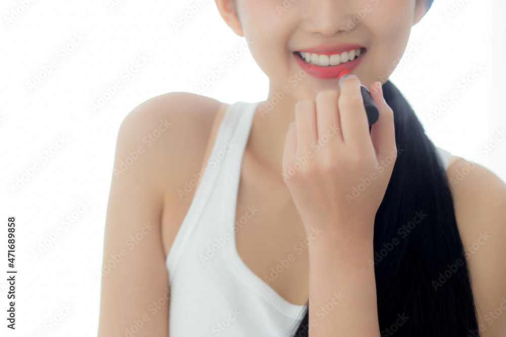 Beautiful young asian woman applying lipstick red on mouth, beauty girl looking facial at mirror for makeup cosmetic with lips elegance, make up with sexy of female, skin care and health concept.