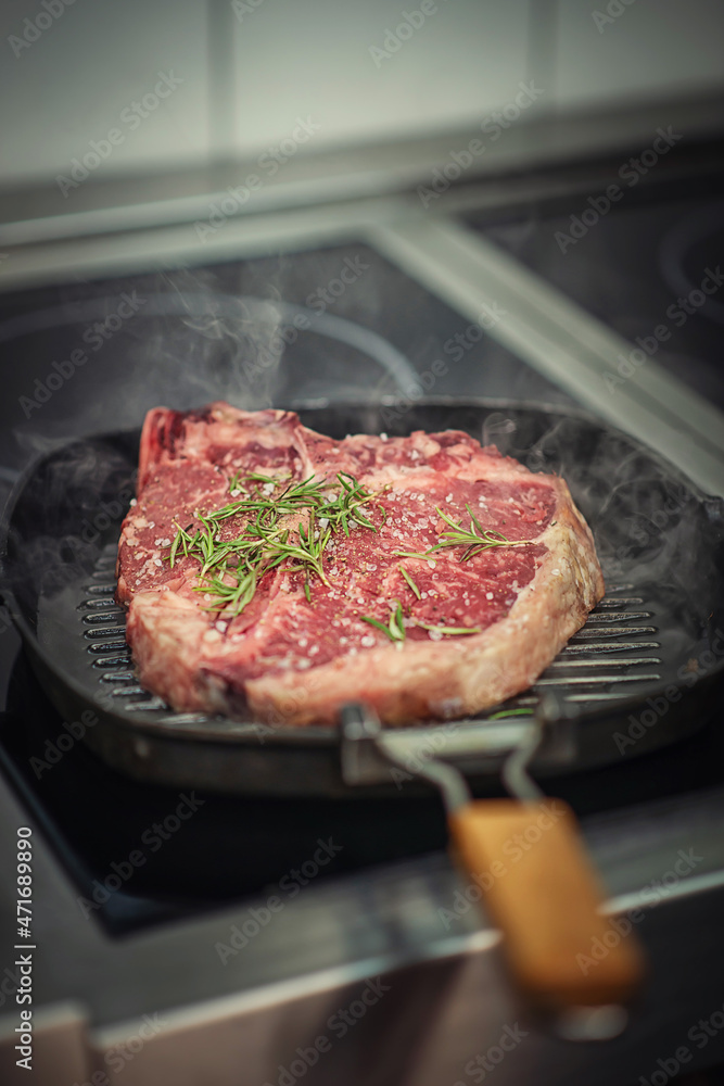 Raw beef steak fillet with ingredients like sea salt, pepper, onion and herbs on black board, product image for restaurant Raw beef steak fillet with ingredients like sea salt, pepper, onion and herbs on black board, product image for restaurant