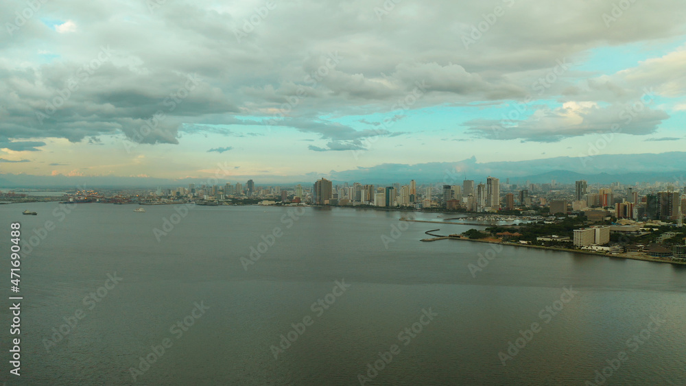 Manila city with skyscrapers, modern buildings and Makati business center at sunset, aerial drone. Travel vacation concept