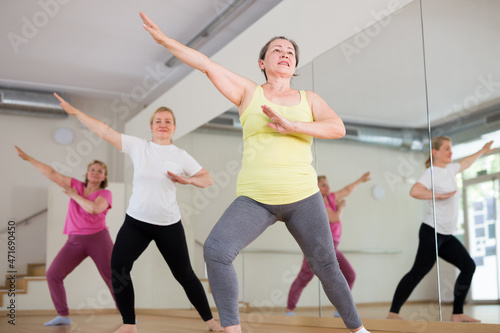 Group of senior women practicing active dancing in class at fitness center